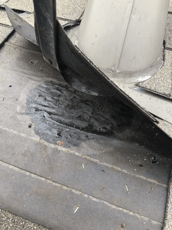 A damaged roof with missing shingles and visible water stains