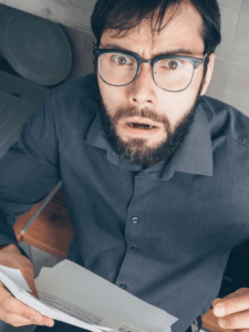 A confused homeowner looking over a suspicious roof estimate