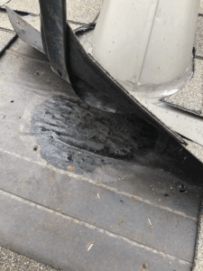Damaged shingles and exposed roof after heavy rain