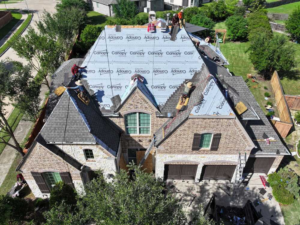 Roofing professionals repairing a period-style roof on a historic property