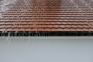 rainfall drops falling from a roof